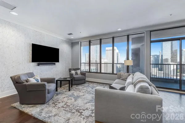 a living room with furniture tv and a large window