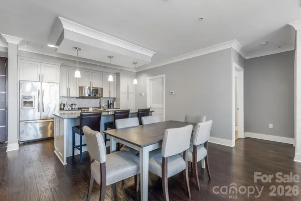 a view of a dining room with furniture and wooden floor