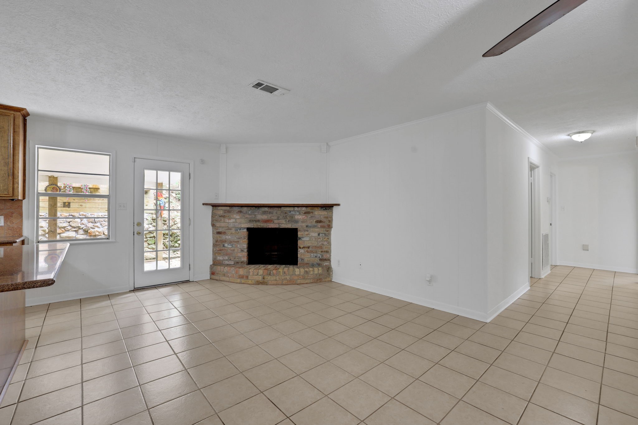 113 Hillendale Street Livingston, TX 77351 - Photo 5 of 36 The living area has durable tile flooring and the fireplace serves as a warm focal point