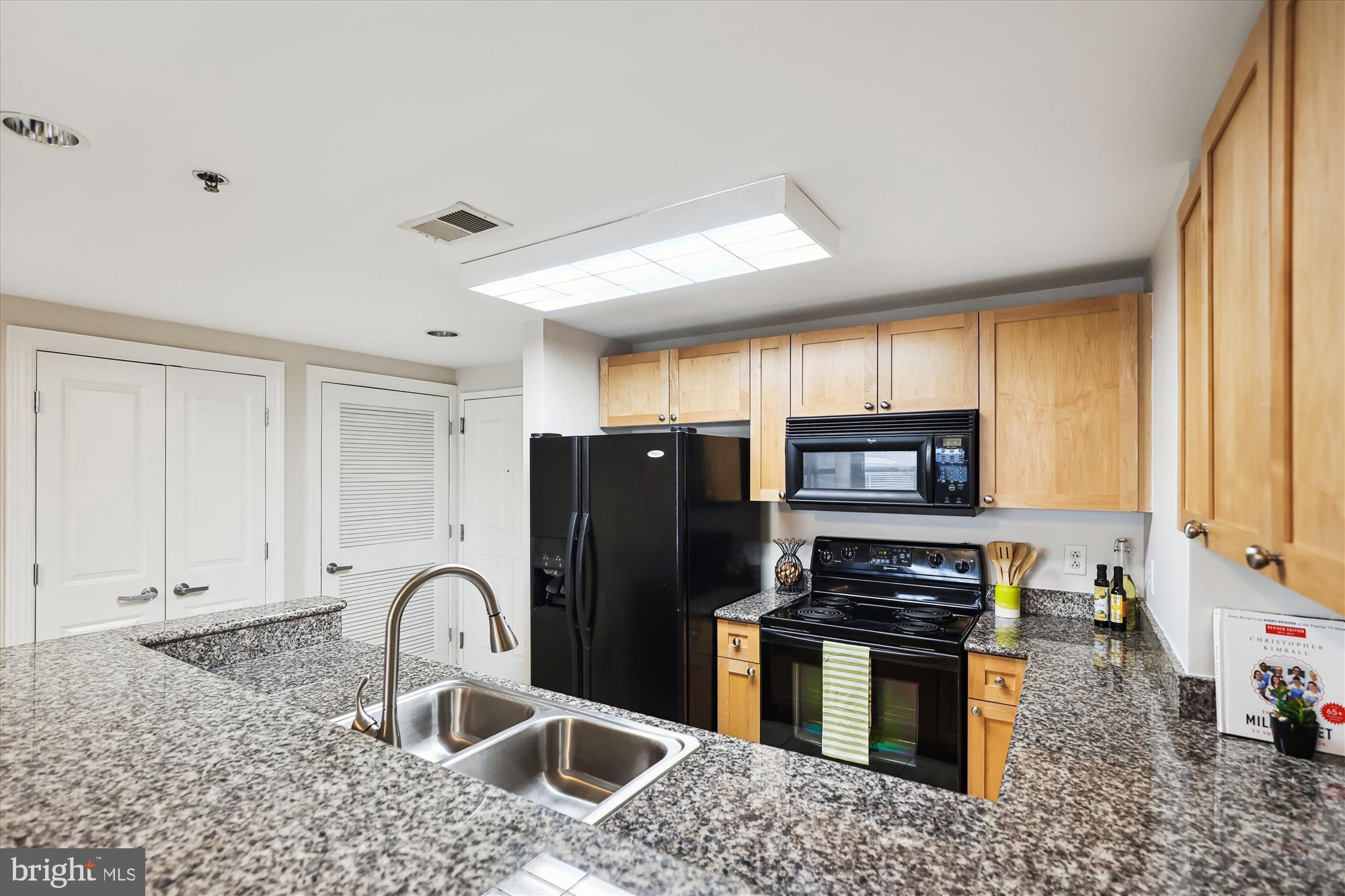 777 7th Street Northwest, Unit 804 Washington, DC 20001 - Photo 17 of 58 a kitchen with stainless steel appliances granite countertop a stove a refrigerator and a sink