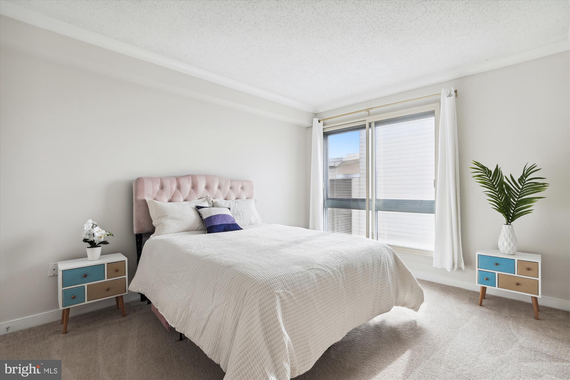 777 7th Street Northwest, Unit 804 Washington, DC 20001 - Photo 19 of 58 a bedroom with a bed and a window
