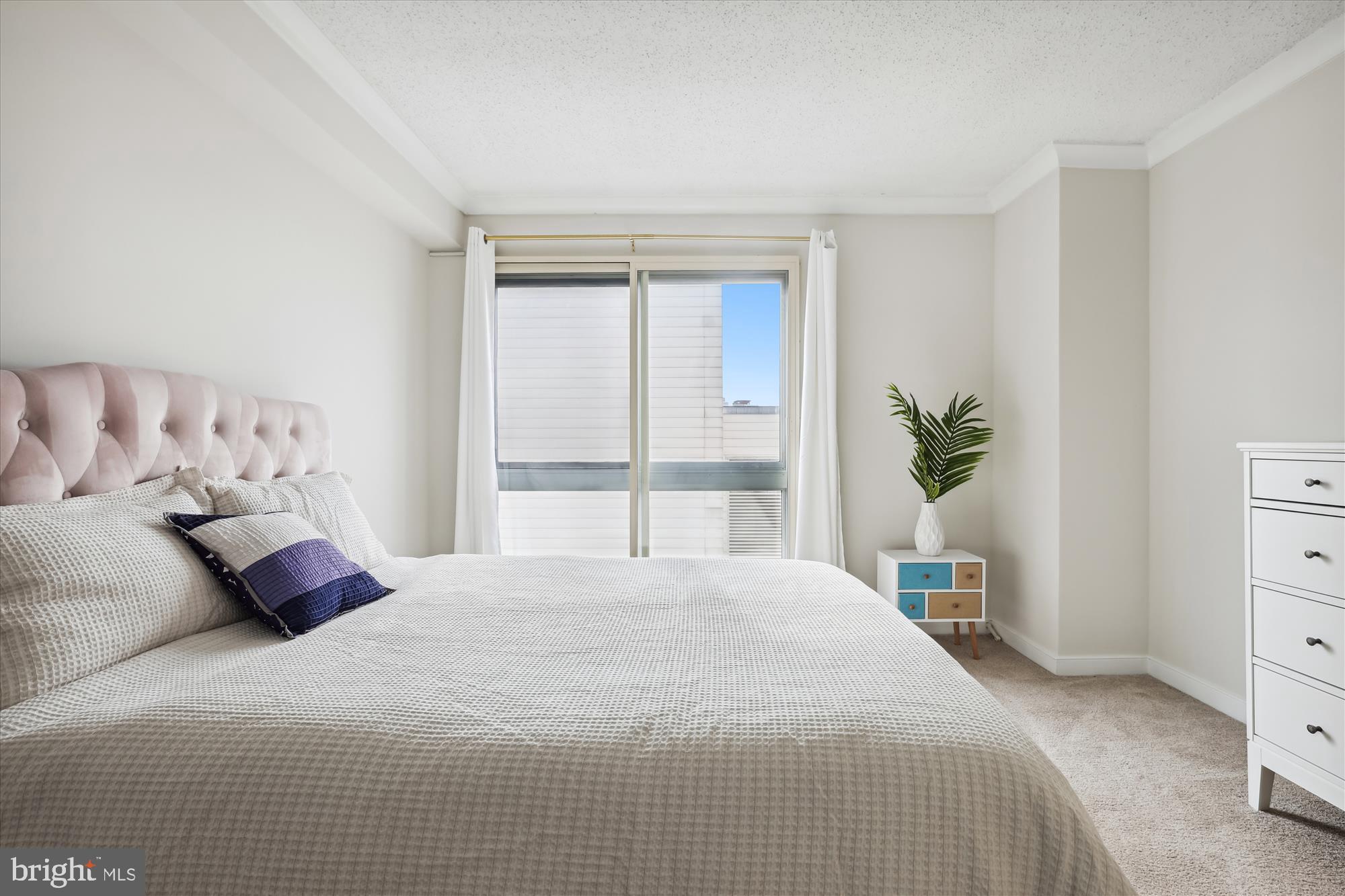 777 7th Street Northwest, Unit 804 Washington, DC 20001 - Photo 21 of 58 a bedroom with a large bed and a dresser