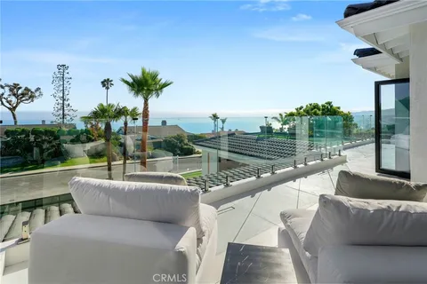 a view of a chairs and table in a balcony