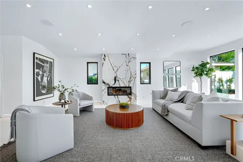 a living room with furniture and view of kitchen