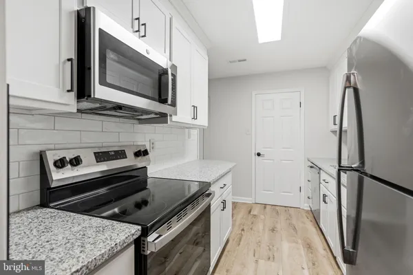 a kitchen with a stove microwave and refrigerator