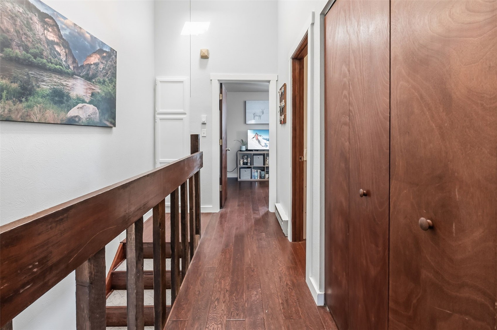 6920 Ryan Gulch Road, Unit 6920 Silverthorne, CO 80498 - Photo 25 of 48 a view of a hallway with wooden floor and staircase