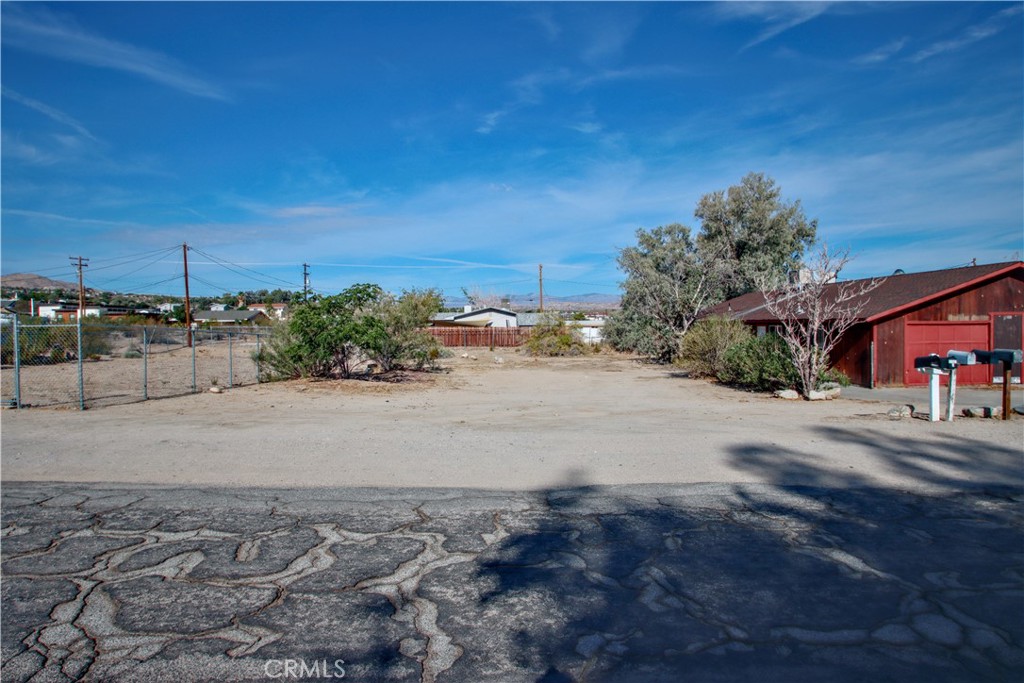 61998 El Reposo Circle Joshua Tree, CA 92252 - Photo 18 of 20 a view of a street with a building in the background
