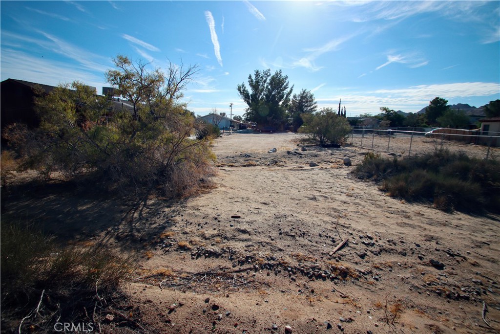 61998 El Reposo Circle Joshua Tree, CA 92252 - Photo 20 of 20 a view of a dry yard with wooden fence and floor