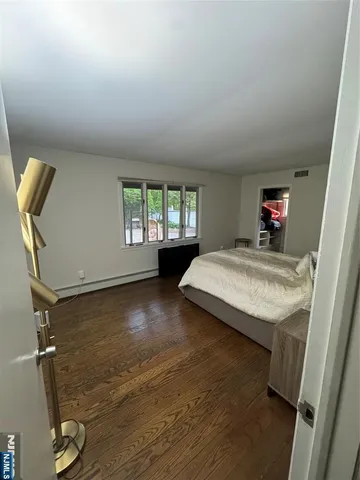 a bathroom with a sink a toilet a mirror and window