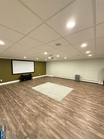 a room with kitchen island a sink and wooden floor