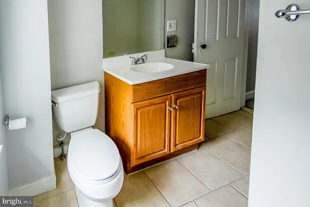 a bathroom with a sink toilet and mirror