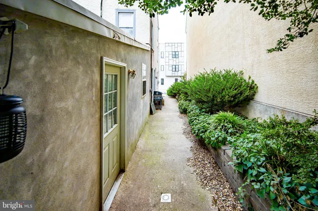 a pathway of a house with a yard