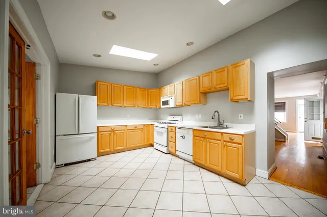 a kitchen with stainless steel appliances a refrigerator and a stove top oven