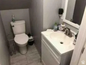 684 East 400 North Logan, UT 84321 - Photo 7 of 27 Compact bathroom featuring a white vanity with a built-in sink, brushed nickel faucet, and a wall-mounted mirror with a white frame