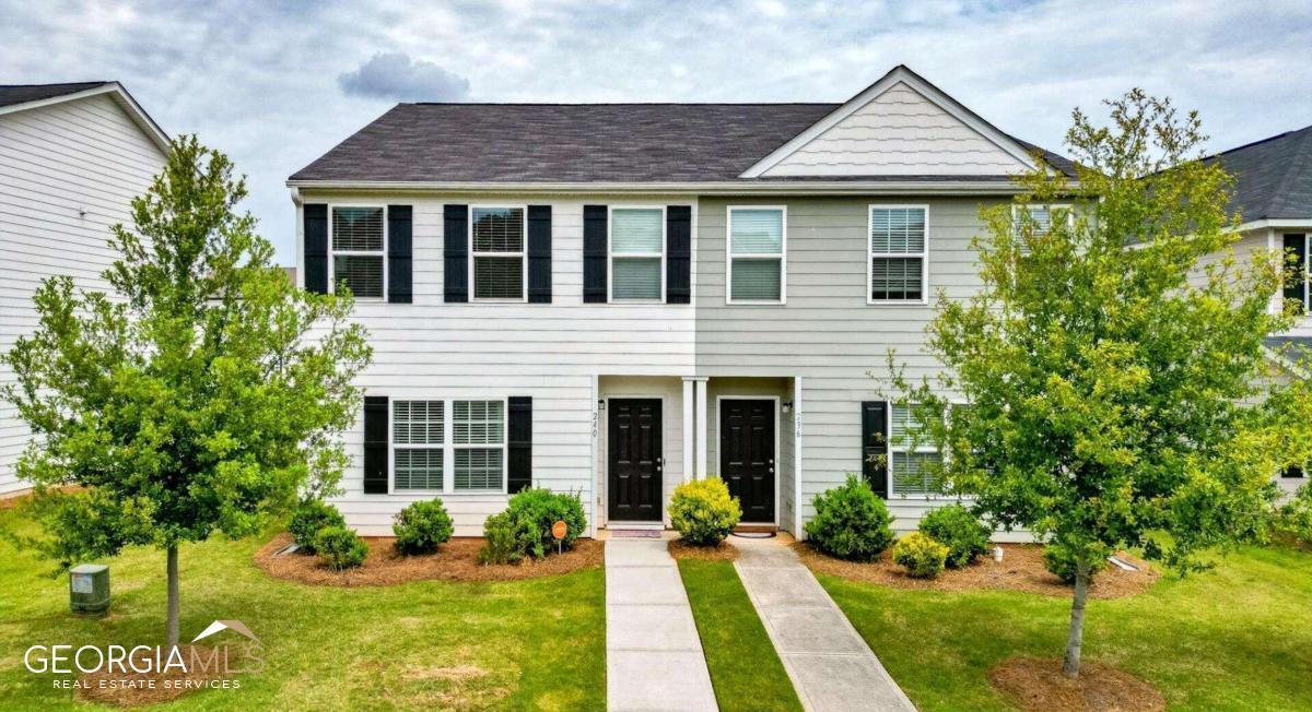 a front view of a house with a yard