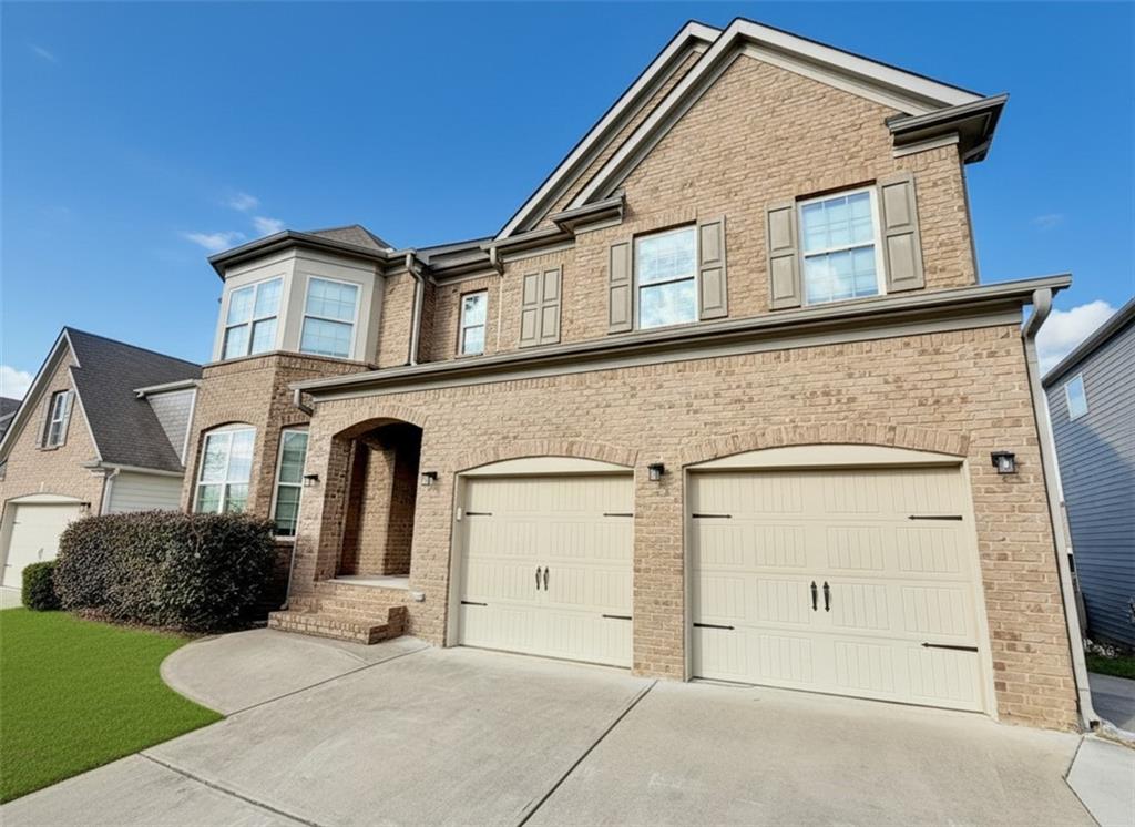 a front view of a house with a yard and garage