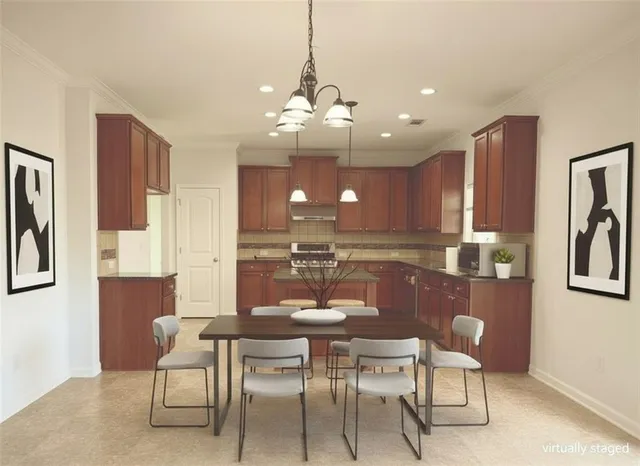 a kitchen with a dining table and chairs
