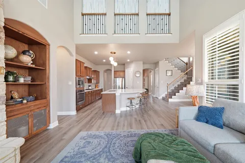 a living room with furniture and a wooden floor