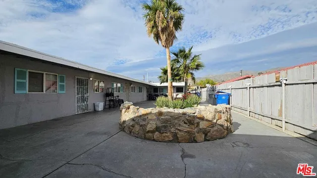 a view of a house with porch and a yard