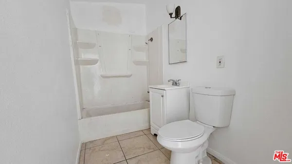 a white toilet sitting next to a bathroom sink