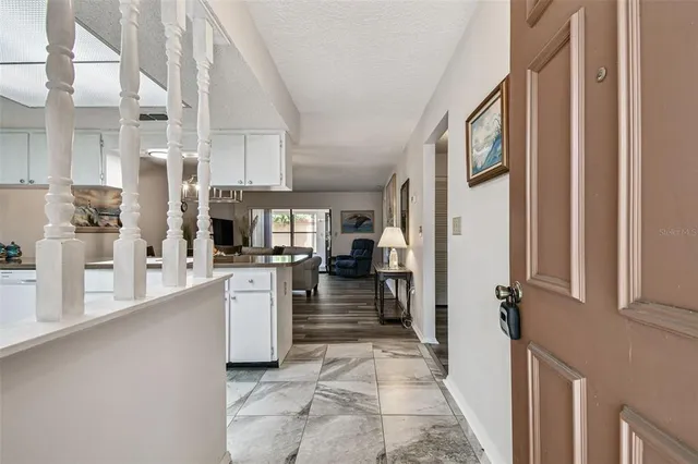 a kitchen with stainless steel appliances granite countertop a sink and a refrigerator