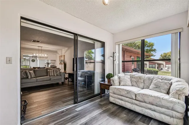 an aerial view of residential houses with outdoor space and trees