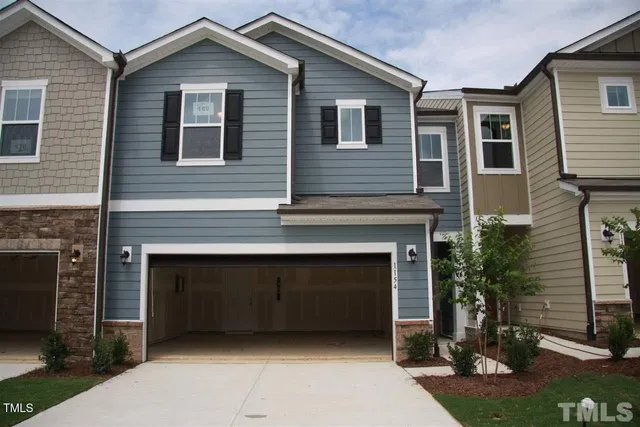 a front view of a house with plants