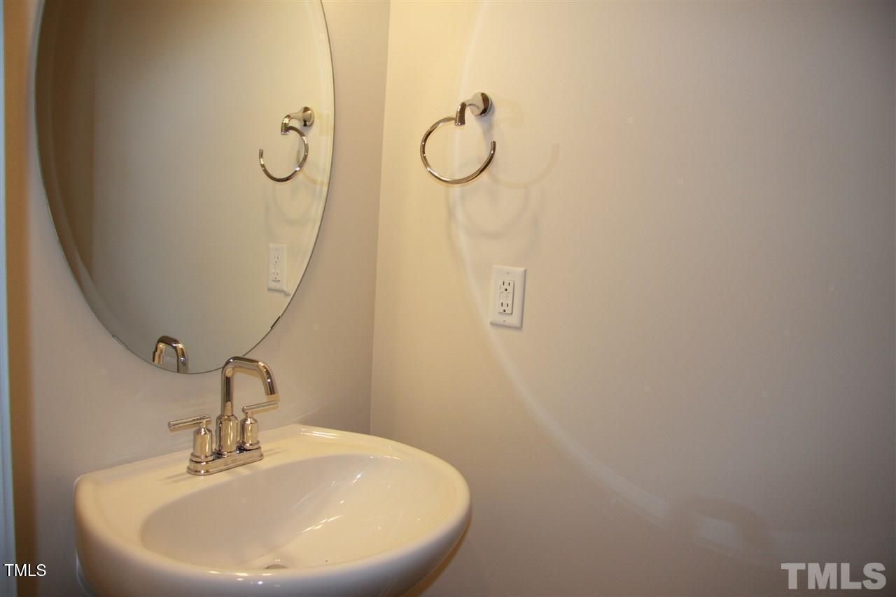 1154 Chestnut Bluff Apex, NC 27502 - Photo 12 of 26 a bathroom with a sink and mirror
