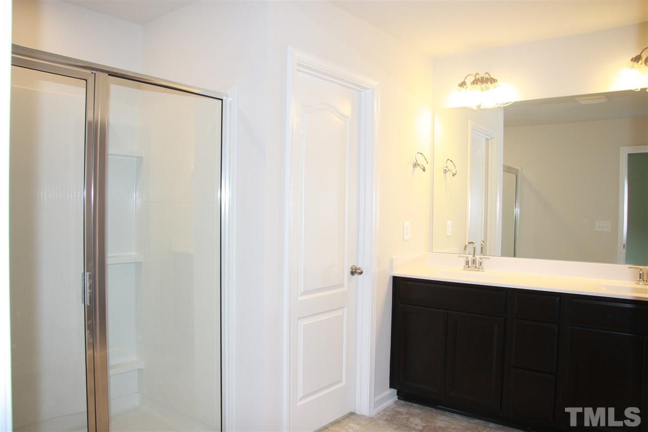 1154 Chestnut Bluff Apex, NC 27502 - Photo 18 of 26 a bathroom with a double vanity sink and a mirror