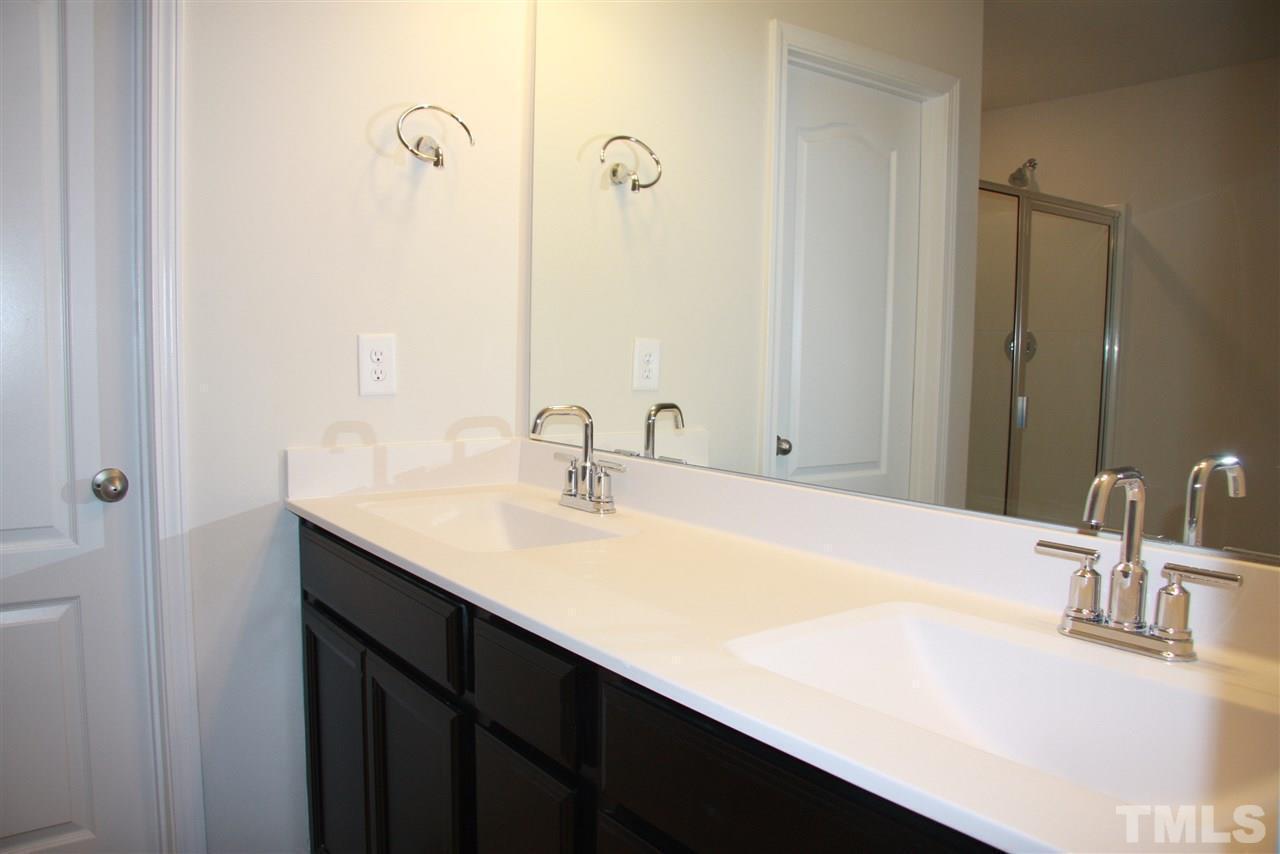 1154 Chestnut Bluff Apex, NC 27502 - Photo 19 of 26 a bathroom with a sink and a mirror