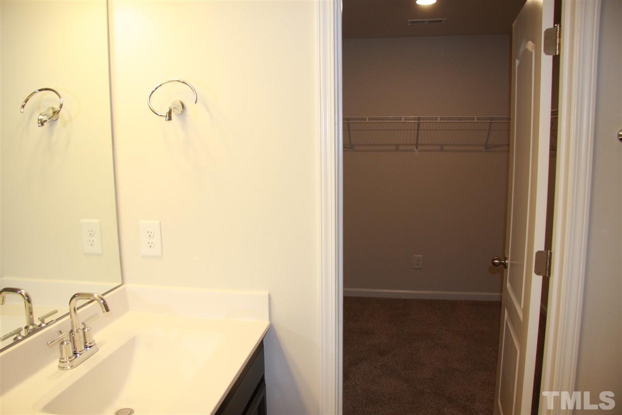 1154 Chestnut Bluff Apex, NC 27502 - Photo 20 of 26 a bathroom with a granite countertop sink and a mirror