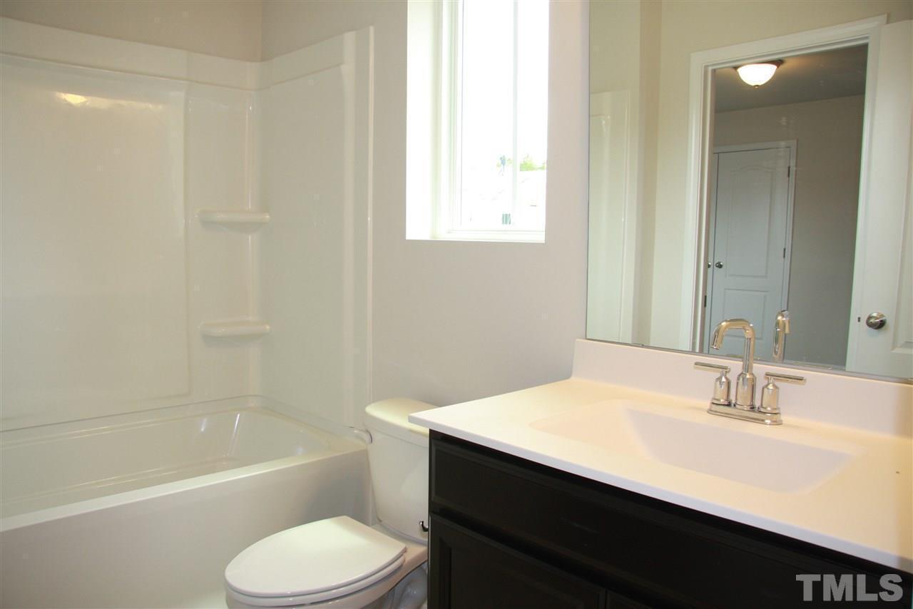 1154 Chestnut Bluff Apex, NC 27502 - Photo 23 of 26 a bathroom with a sink toilet tub and shower