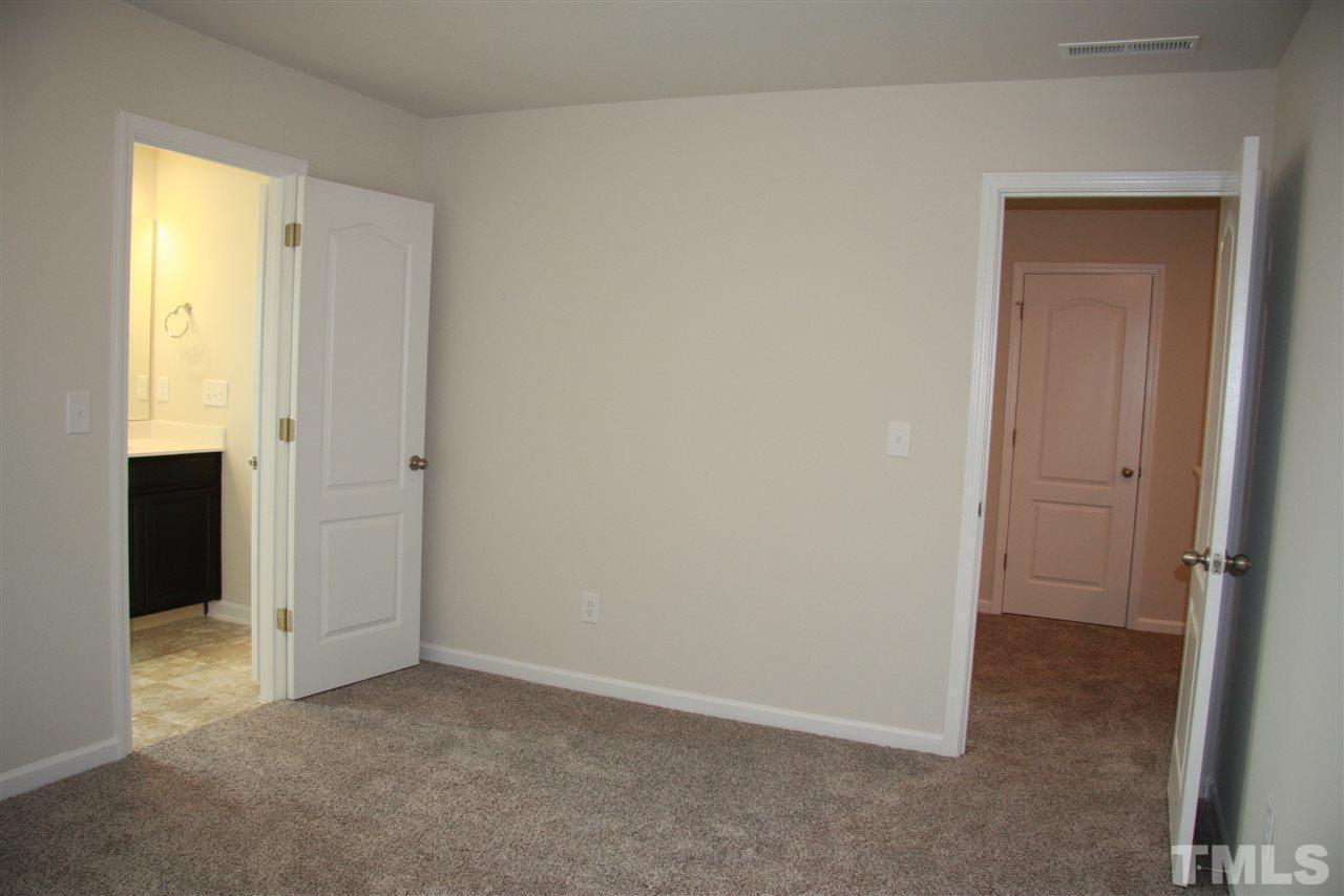 1154 Chestnut Bluff Apex, NC 27502 - Photo 24 of 26 a view of an empty room with closet and a bathroom
