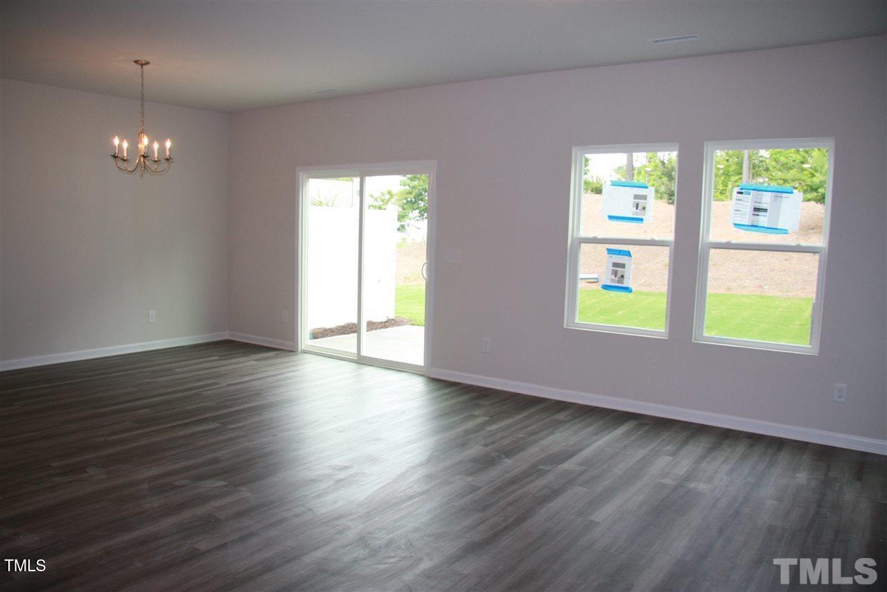 1154 Chestnut Bluff Apex, NC 27502 - Photo 3 of 26 a view of empty room with wooden floor and fan