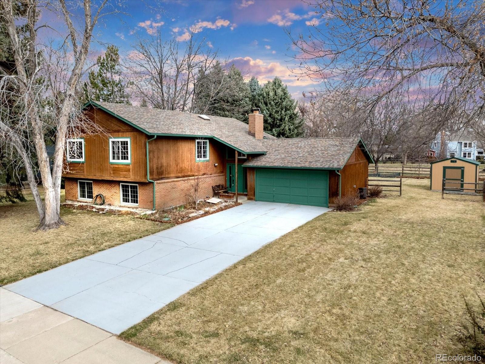 a front view of a house with yard and covered with snow