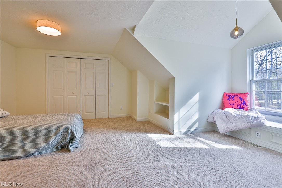 32887 Cedar Road Mayfield Heights, OH 44124 - Photo 37 of 44 Bedroom with lofted ceiling, light carpet, and a closet