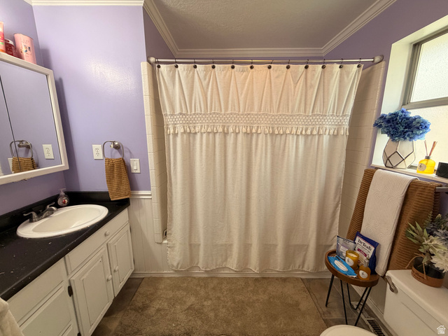 110 South 200 East Springville, UT 84663 - Photo 15 of 23 Full bathroom featuring ornamental molding, vanity, shower / bath combo with shower curtain, and a textured ceiling