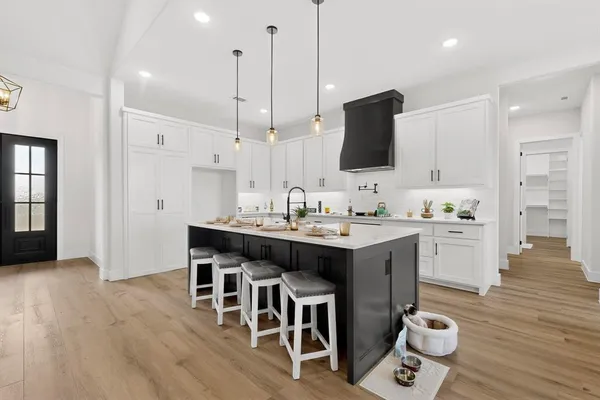 a kitchen with a sink cabinets and wooden floor