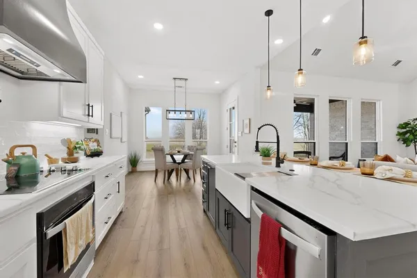 a kitchen with sink stove and cabinets