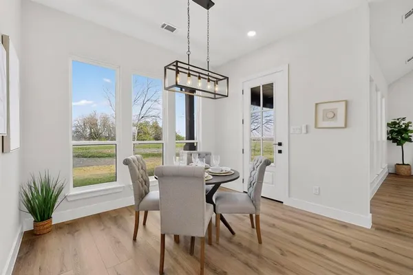 a view of a dining room with furniture wooden floor and a chandelier