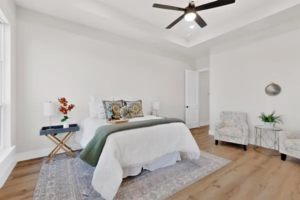 a bedroom with a balcony a bed and a chandelier