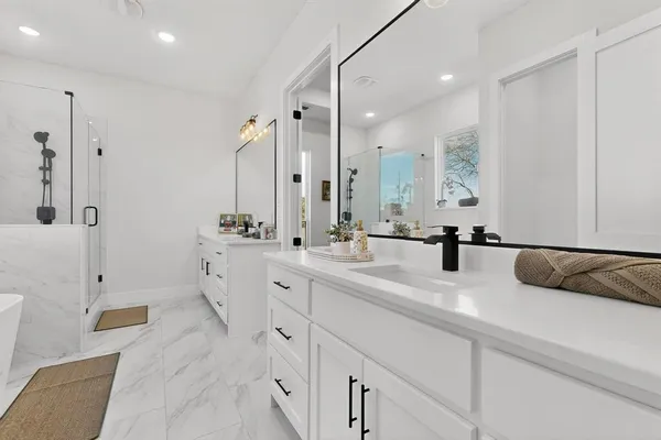 a bathroom with a bathtub a sink and a shower