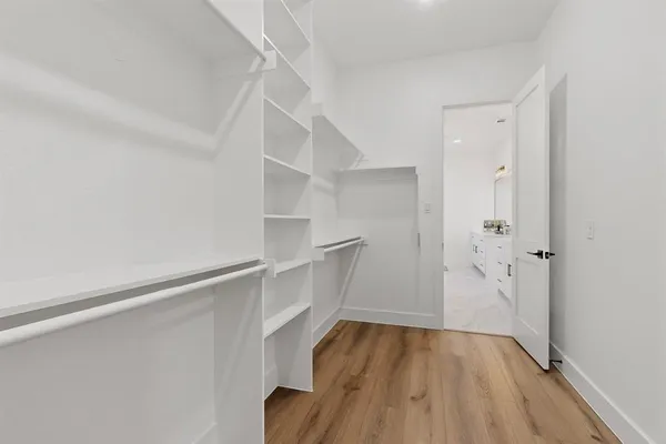 a bathroom with a double vanity sink mirror and shower