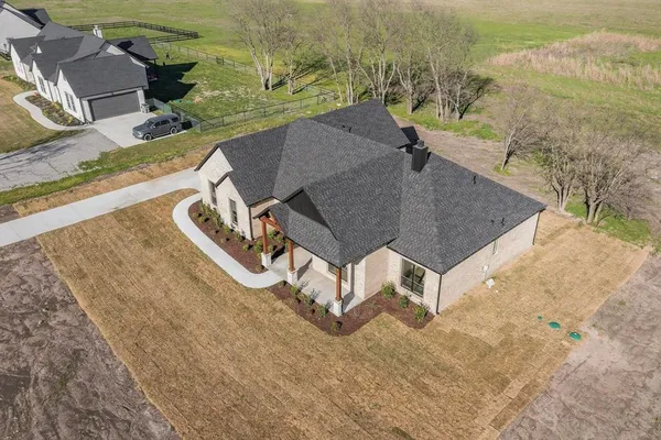 an aerial view of a house with a yard