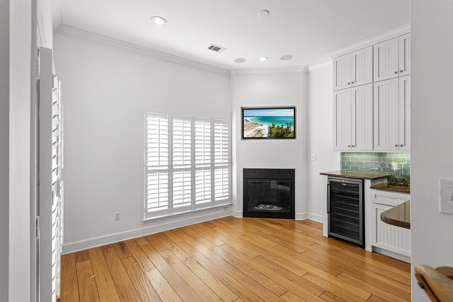 4460 Clipper Cove Destin, FL 32541 - Photo 11 of 37 an empty room with windows a fireplace and wooden floor