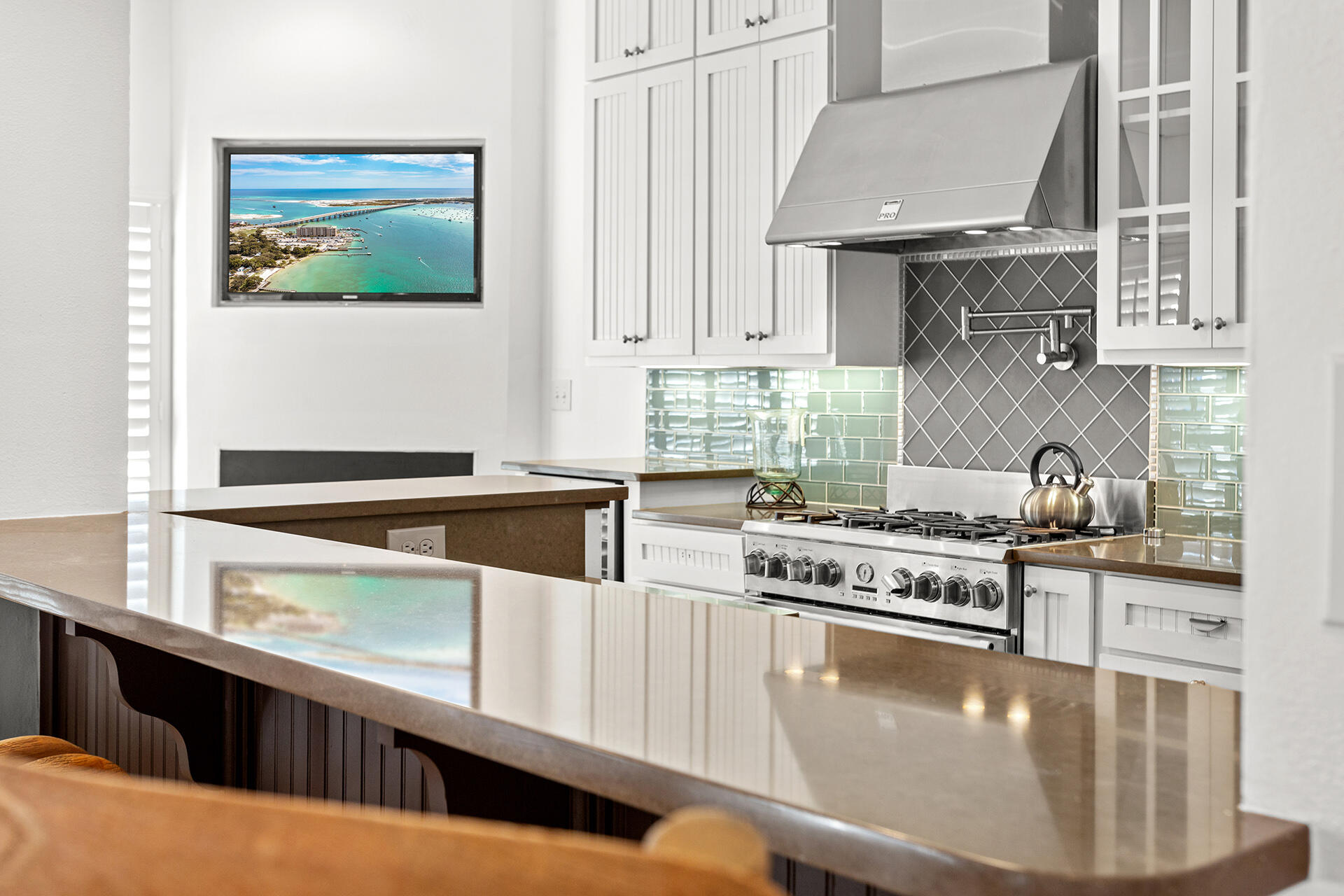 4460 Clipper Cove Destin, FL 32541 - Photo 13 of 37 a kitchen with stainless steel appliances granite countertop a stove a sink and a microwave