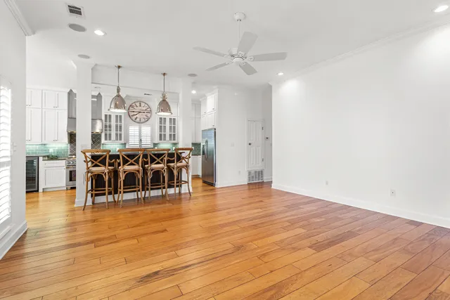 a living room with furniture a wooden floor and chandelier
