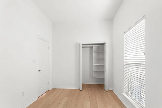a view of a room with wooden floor and closet