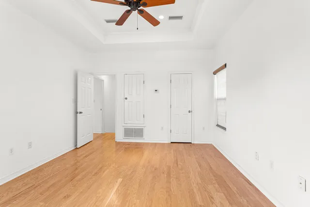 a view of empty room with wooden floor