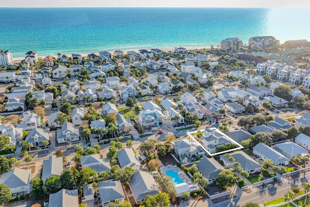 an aerial view of a city with lots of residential buildings and ocean view